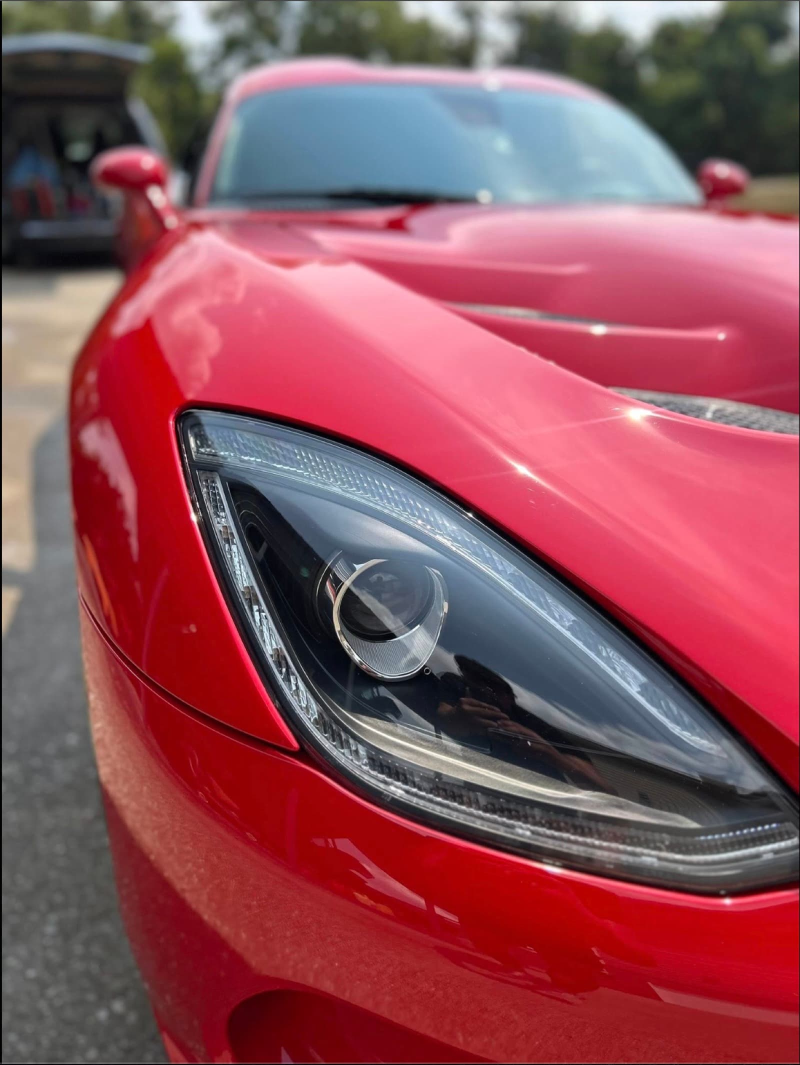 Restored clear headlight lens on a red Viper after a headlight restoration