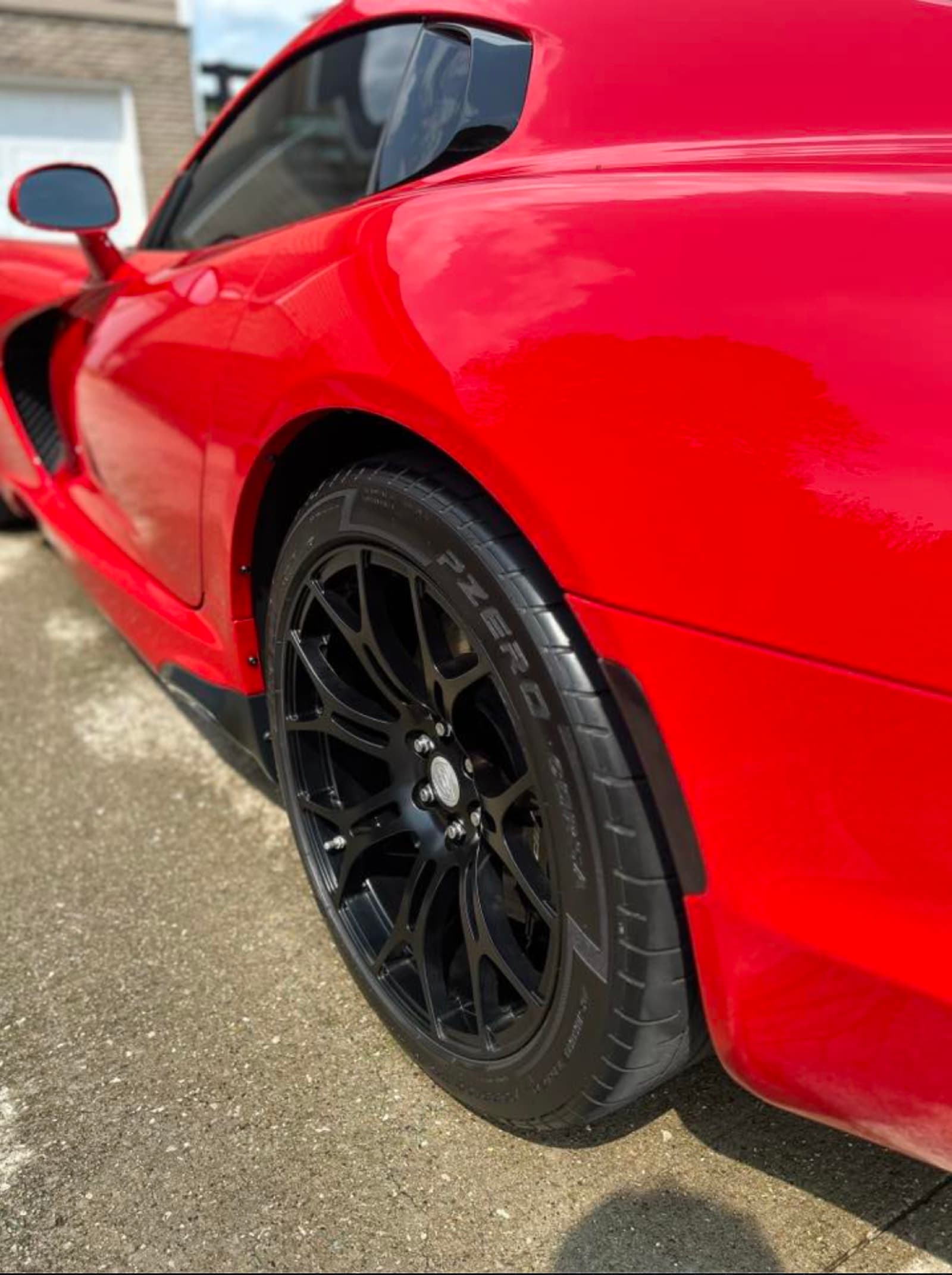 Glossy red paint reflection on a Viper rear quarter — ceramic coating finish